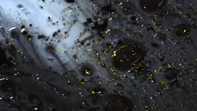 Beautiful colorful background with glitter and colored bubbles in oil and watercolor. Golden sparkle particles.  Macro oil ink bubbles and drops. Chroma galaxies magic fluids.Wallpaper pattern of gold