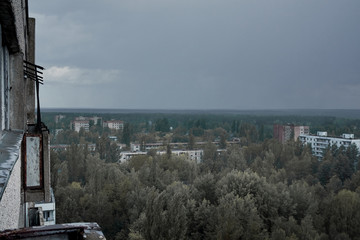 Fototapeta na wymiar Pripyat city in the rain from the roof of a multi-storey building