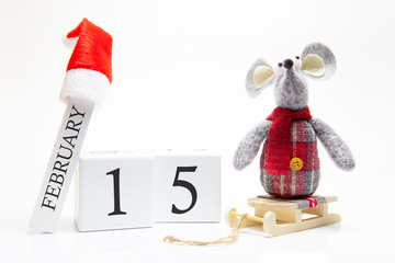 Wooden calendar with number February 15. Happy New Year! Symbol of New Year 2020 - white or metal (silver) rat. Christmas decorated.