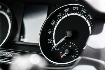 Naklejka premium Speed Tachometer or gauge in modern car. Control vehicle dashboard detail.