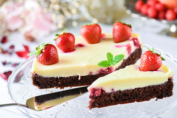Fresh tart piece with forest fruits like strawberries on top and vanilla cream..Finest cake or dessert selective focus.