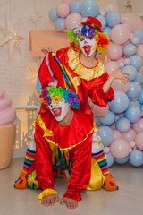 Funny clowns from the circus. Clown boy and clown girl show emotions
