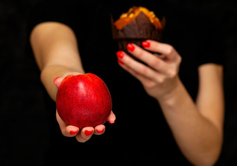 girl holds an apple in her hand and offers healthy food, healthy nutrition