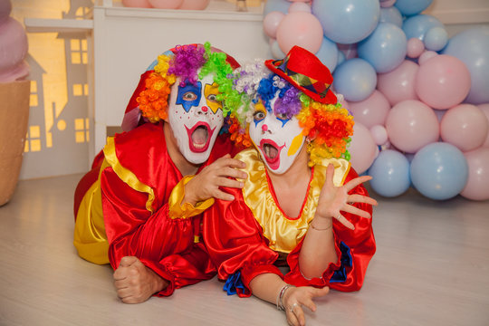 Funny clowns from the circus. Clown boy and clown girl show emotions