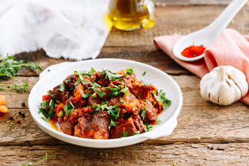 Meat with vegetables in tomato spicy sauce