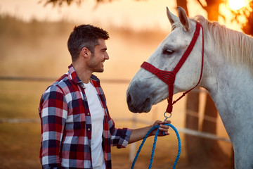 Happy man bonding with his horse