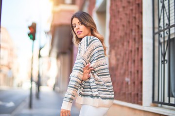 Young beautiful woman smiling happy and confident. Standing and walking at town street