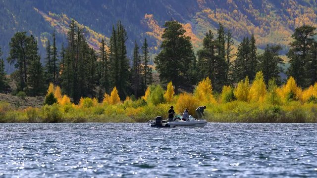 Men fishing in a lake against a background of fall colors in the Rocky Mountains of Colorado