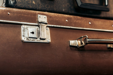 Vintage vintage black and brown suitcases lie on a shelf