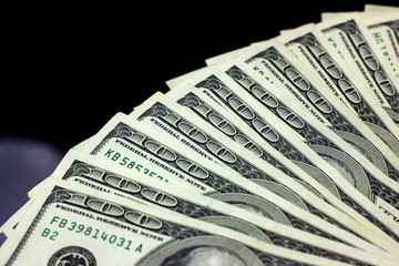 Hundred dollars usa on black background. Finance and money concept.