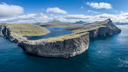 Leitisvatn lake and Bosdalafossur waterfall on Vagar island aerial view, Faroe Islands © David
