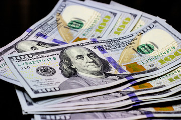 Hundred dollars usa on black background. Finance and money concept.