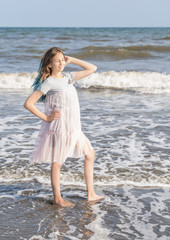 Fototapeta na wymiar Adorable girl dancing by the sea