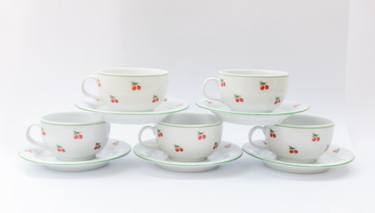 Porcelain coffee or tea mugs with cherry pattern isolated - retro midcentury classic cups - mass product china ware