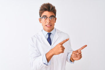 Young handsome sciencist man wearing glasses and coat over isolated white background Pointing aside worried and nervous with both hands, concerned and surprised expression