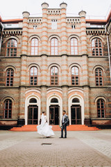 Obraz premium Lovely couple walking on the playground near the exclusive building