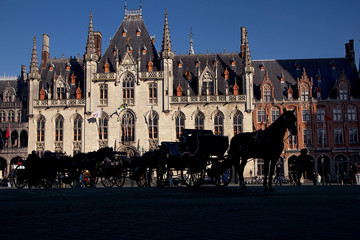 Naklejka na ściany i meble Horse carriages on Grote Markt square, Brugge, Belgium,