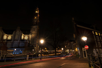 Obraz na płótnie Canvas Light trails of bikes and a nightscape in Amsterdam