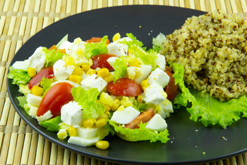 Quinoa groats and salad with pickled cheese, eggs and vegetables