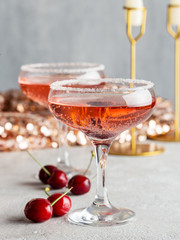 Cherry champagne in glasses with berries on party