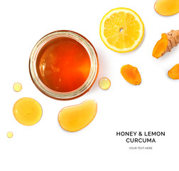 Creative layout made of honey, curcuma and lemon on white background. Flat lay. Food concept. Macro concept.