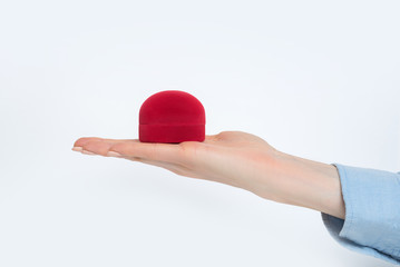 Open female palm with a red jewelry box. Present. White background