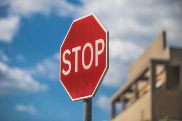 Stop sign against blue, color photo.