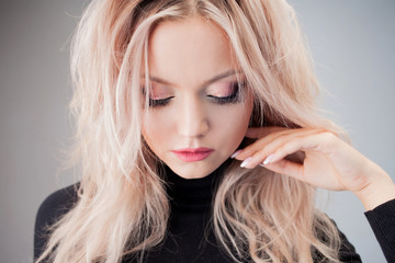 Charming blonde with sloppy curls, close-up