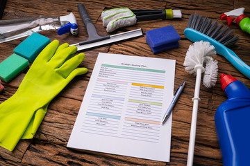 Cleaning Products Around Weekly Cleaning Plan Form With Pen - obrazy, fototapety, plakaty