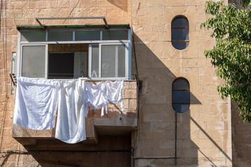 Drying white clothes on balcony.