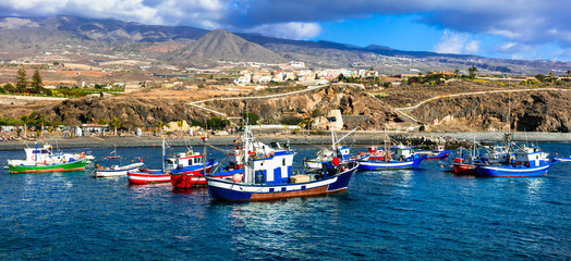 Tenerife holidays. Playa San Juan -pictorial beach with traditional boats . Canary islands - obrazy, fototapety, plakaty