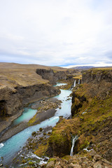 Obraz premium Beautiful landscape of Sigoldugljufur canyon with many small waterfalls and the blue river in Highlands of Iceland
