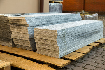 Piles of granite marble slabs.  Stone sheets for decorative construction.