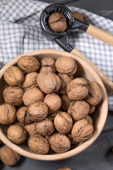 Whole walnuts in a wooden bowl.