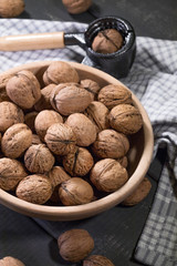 Whole walnuts in a wooden bowl.