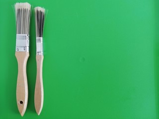 brush and paint on green background