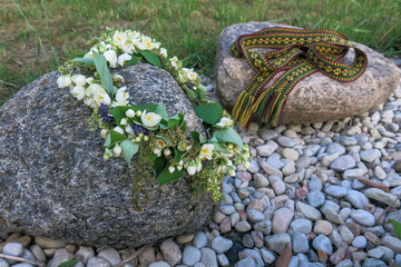 folk belt and flower crown, symbols of Latvian identity