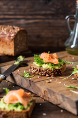 Whole grain sandwiches with avocado mousse, smoked salmon and lamb's lettuce