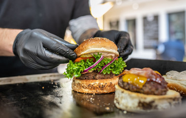 Preparing of fresh burger with potato fries chips on grill - Powered by Adobe