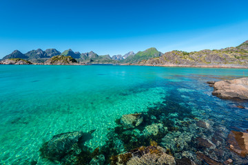 Vestfjorden coastline as viewed from southern cup of Arsteinen island in western direction. Islands of Lofoten Archipelago is at background. Nordland, Norway.