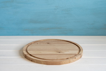 Cheese board on a table on a blue background with free space.