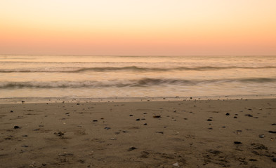 Long exposure shot of ocean waves at sunset