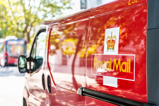 London, UK - September 13, 2018: Red Royal Mail delivery van truck car on street road in city in Pimlico