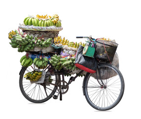 Old bycycle carry a lot of fresh bananas for sale. It's fruit for good health.