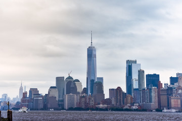 Cityscape of the financial district of Manhattan from Liberty Island, in a foggy day.