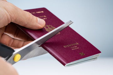 Human Hand Cutting Passport With Scissor