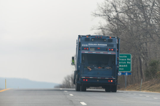 Thurmont, USA - April 6, 2018: Exit Sign On Highway 15 In Maryland And Garbage Recycling Trash Truck On Road During Day