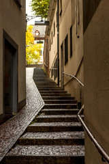 Narrow pedestrian street with stairs in Old city center of Basel