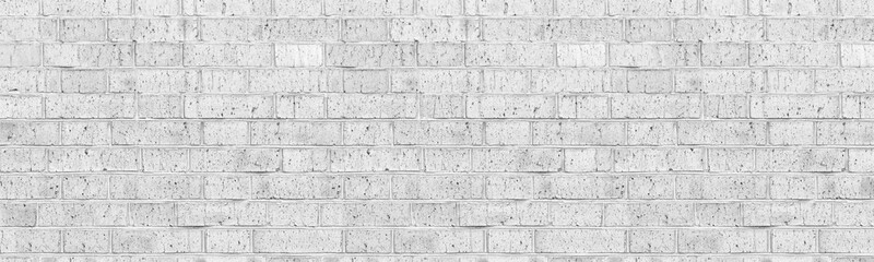 Fototapeta premium Wide panoramic white brick wall texture. Whitewashed shabby brickwork. High key faded vintage background