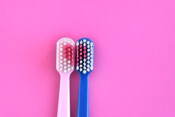 Toothbrush for personal healthcare dental care on purple background.Two bright toothbrushes with red heart. Toothbrush for personal healthcare. St. Valentine's Day concept. Lovers toothbrushes